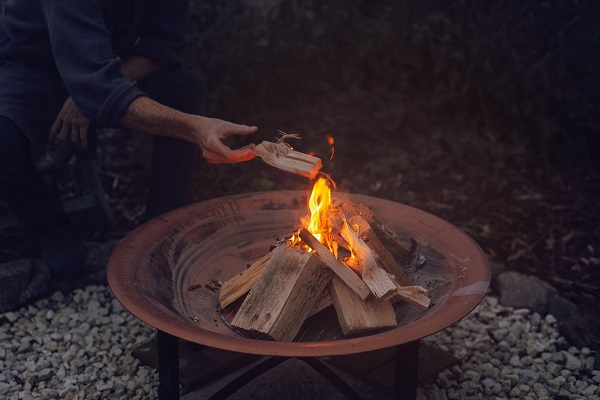Burning fire pan with sand in the bottom