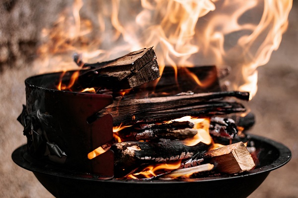 Firepit fuel burning in a metal burner pan