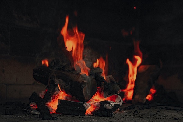 Burning treated wood in a fireplace